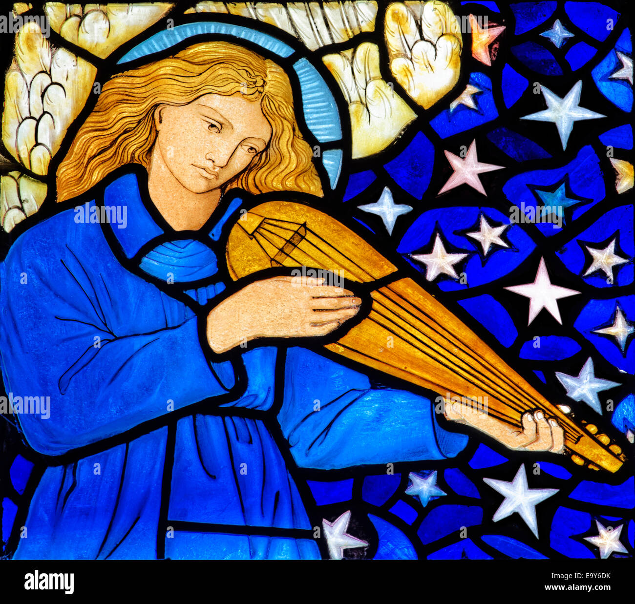 Stained glass depicting a winged angel playing a mandolin by William Morris, Staveley Church, Lake District, Cumbria, UK Stock Photo