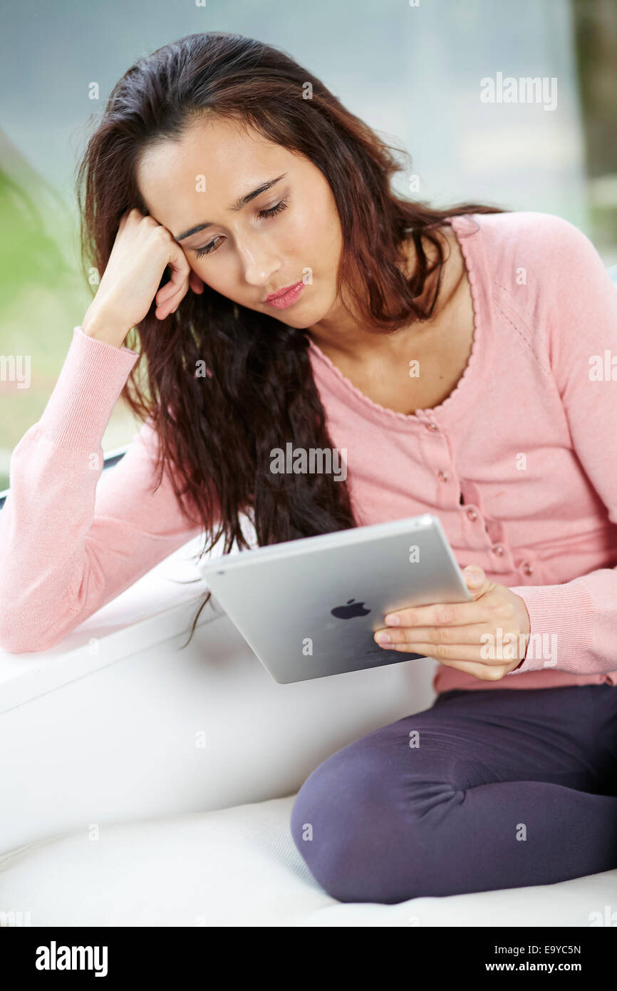 Girl browsing websites using iPad Stock Photo