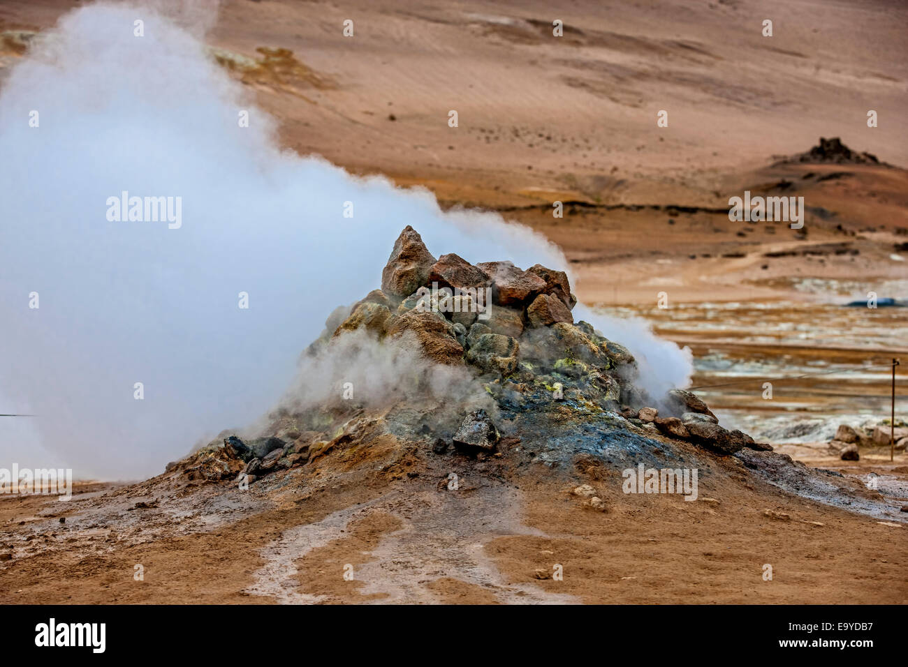 Fumarole evacuating pressurized hot sulfurous gases from volcanic activity in the geothermal area of Hverir Iceland near Lake My Stock Photo