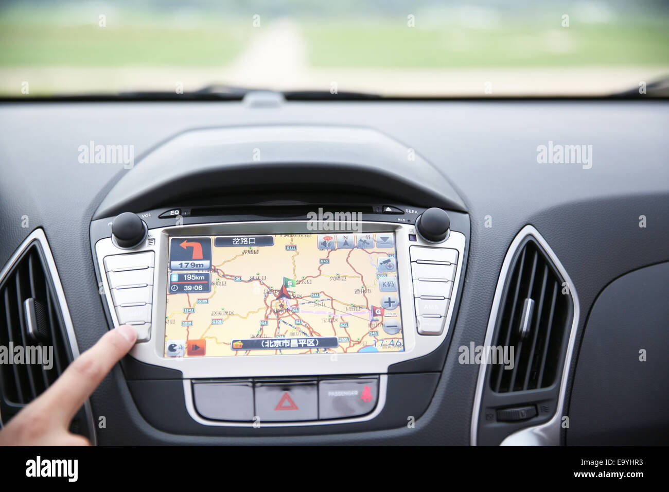 Human finger pointing to GPS map in a car Stock Photo