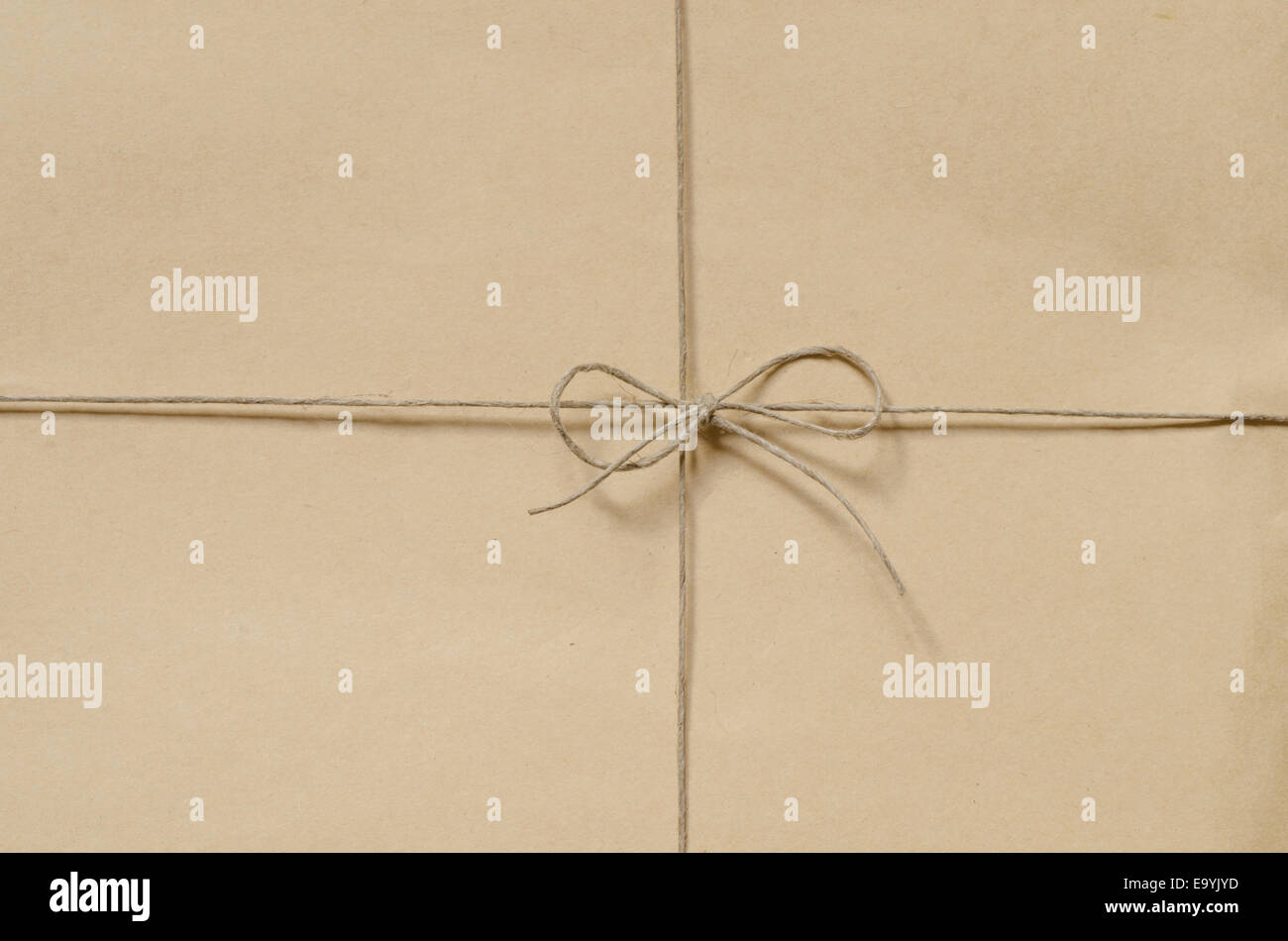 brown cardboard package background tied with twine Stock Photo