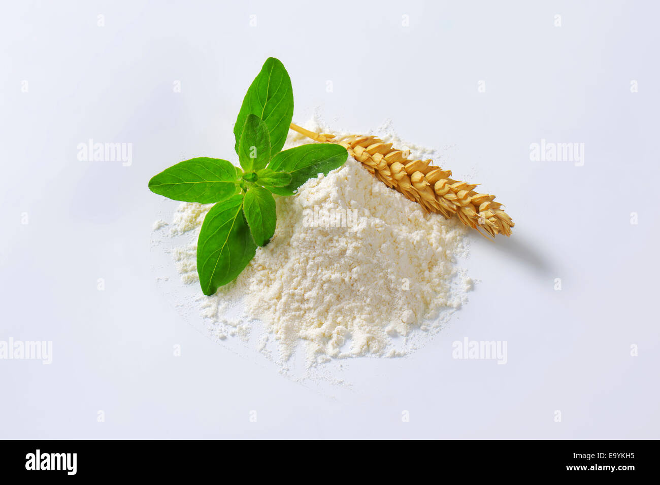 Pile of finely ground flour and wheat ear Stock Photo
