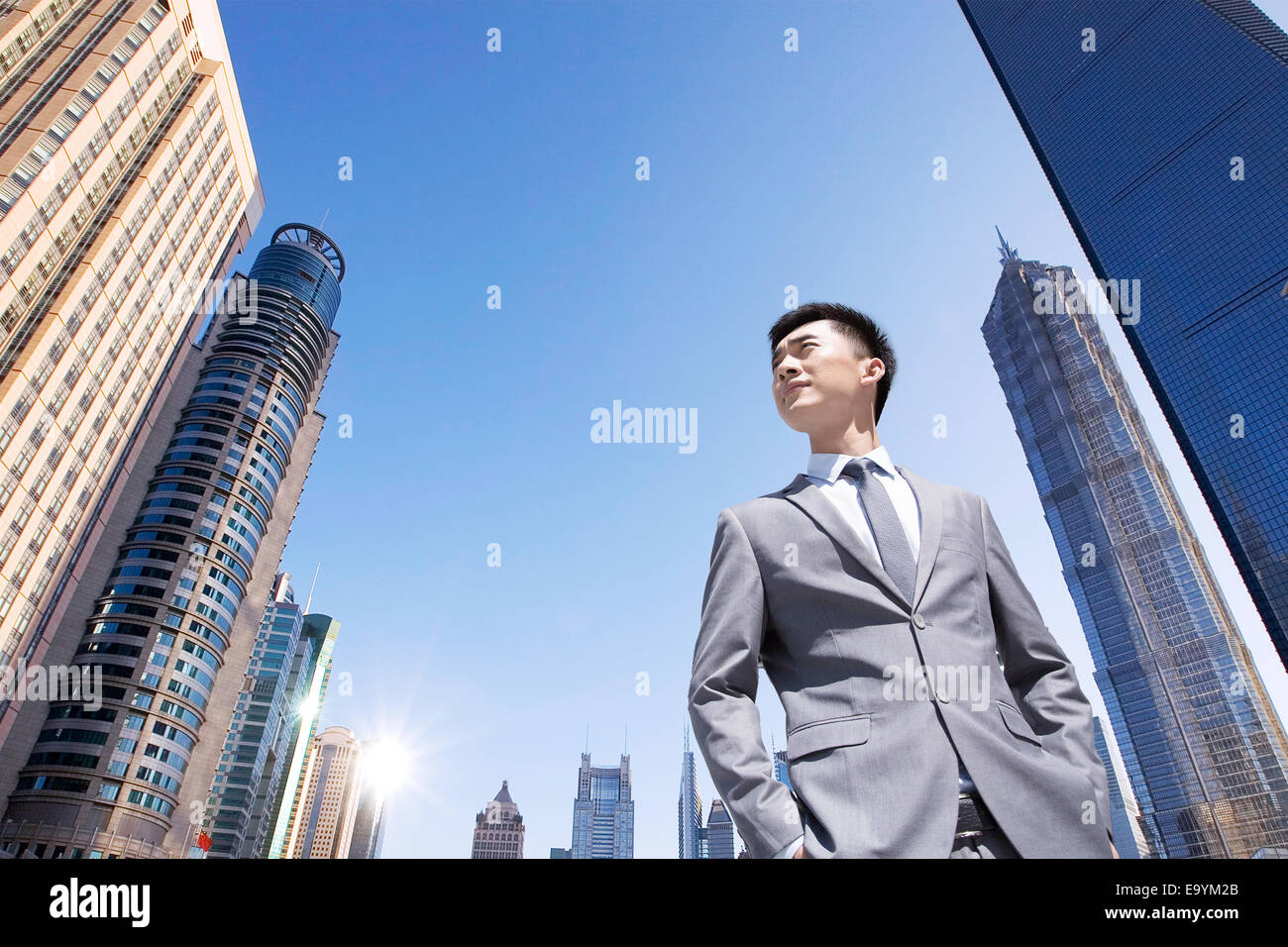 Man In Building Young business man standing buildings in the middle Stock Photo - Alamy