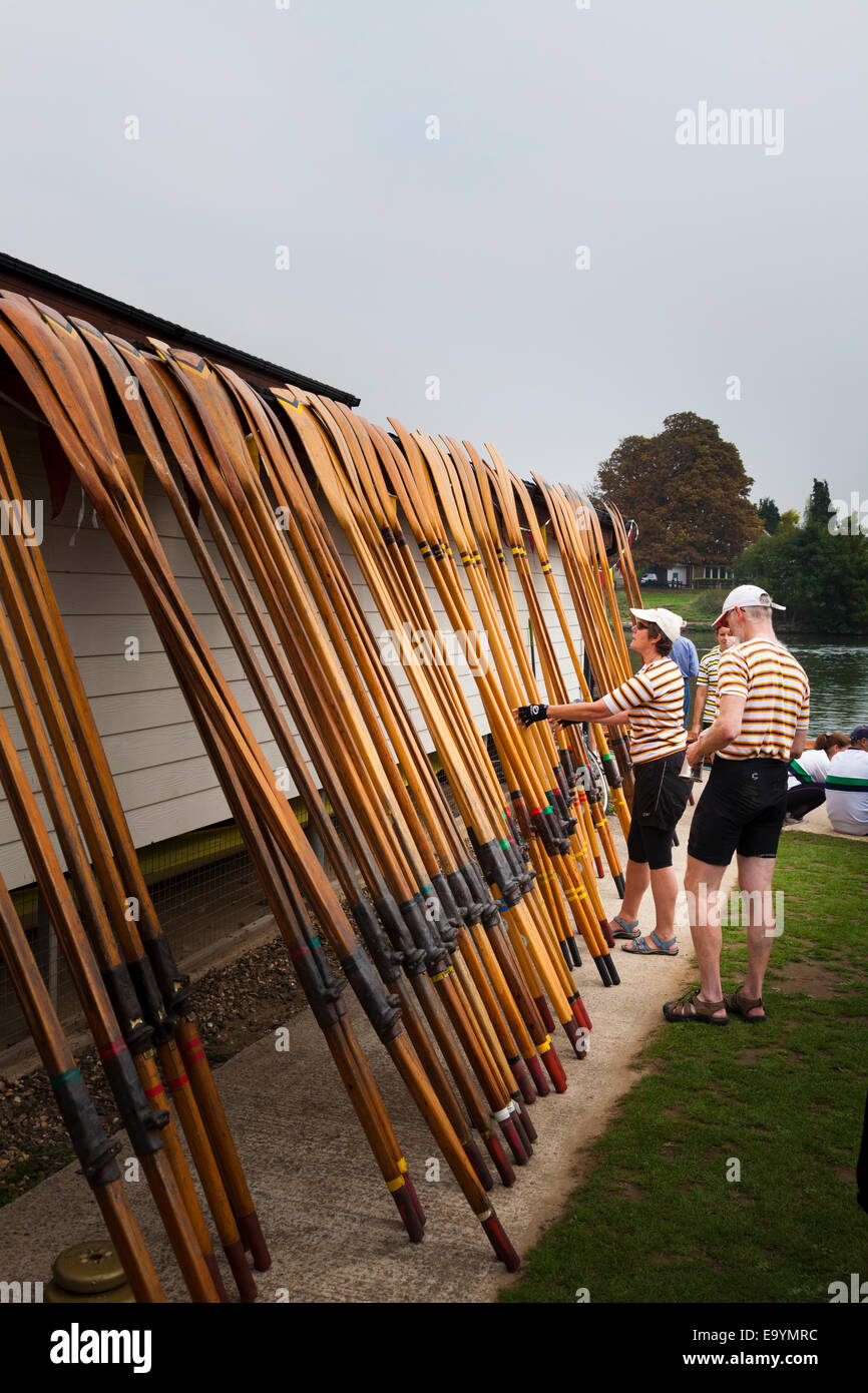 Club members selecting their oars for their skiff Stock Photo