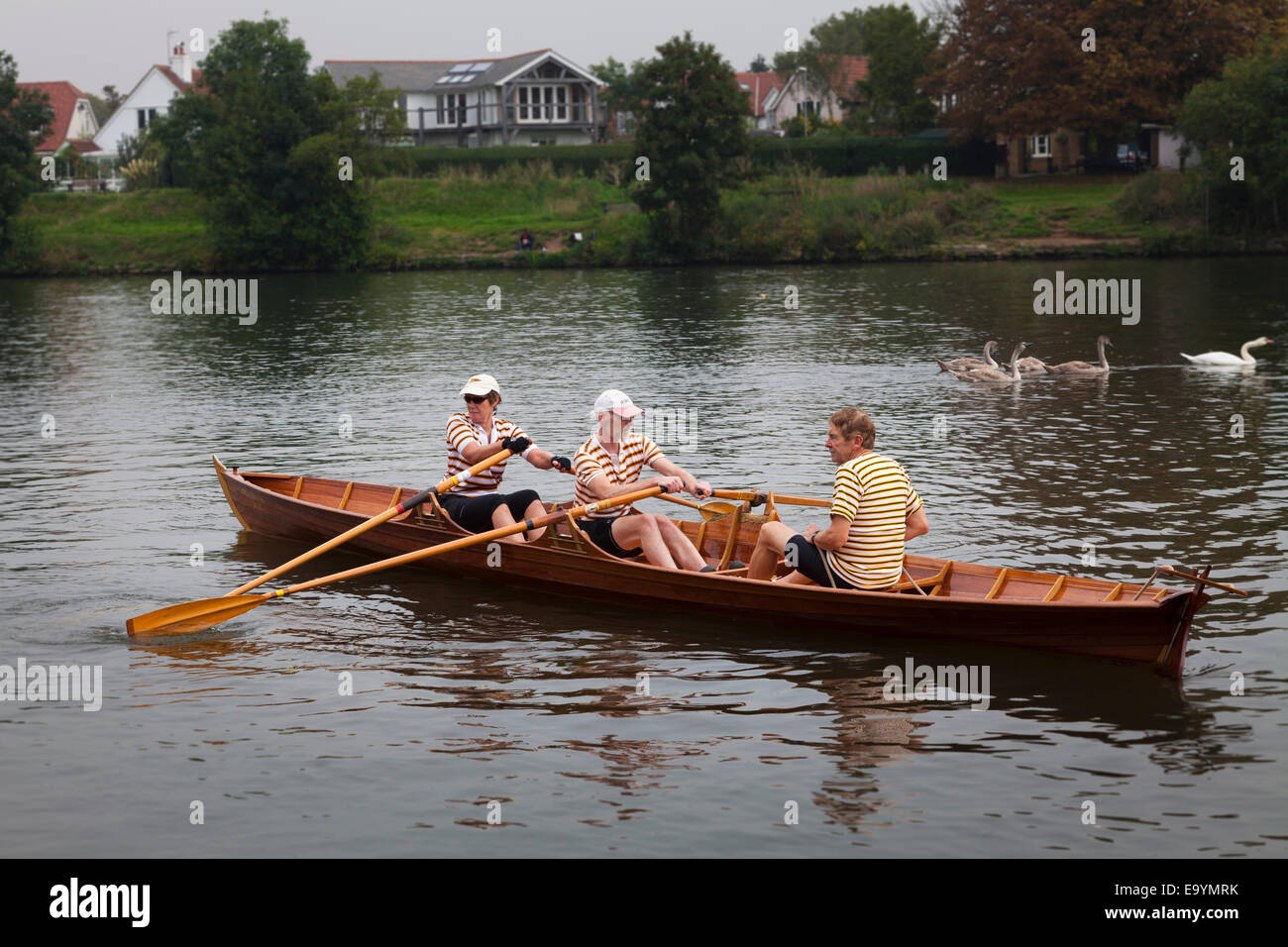 Rowing club members set off in their skiff on the thames Stock Photo