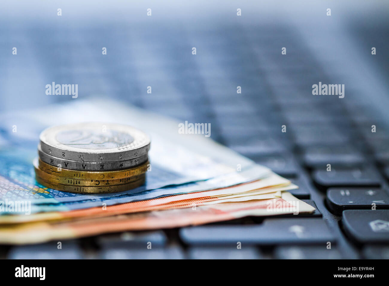 Money and coins on keyboard of computer. Online banking. Euro banknotes ...