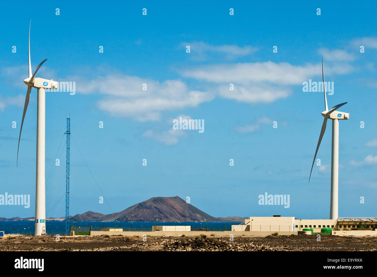 Wind power turbines & Los Lobos island onnorthern coast near this resort town; Corralejo, Fuerteventura, Canary Islands, Spain Stock Photo