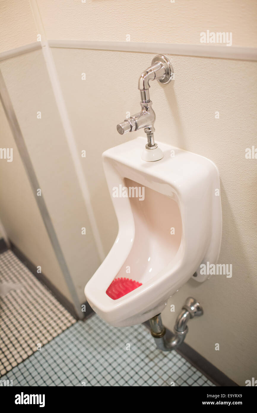 A Urinal in a Public Restroom Stock Photo
