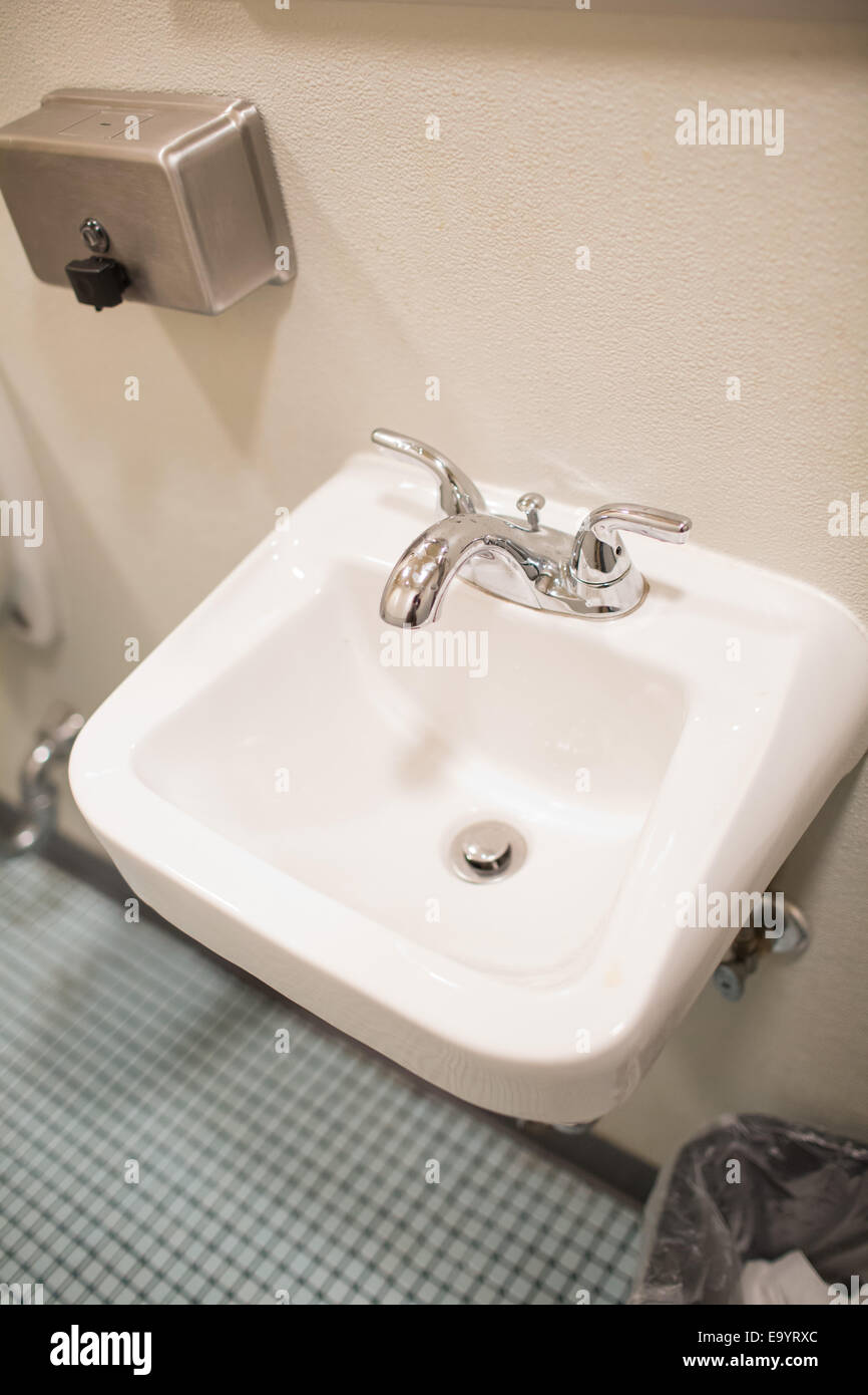 A sink in a public bathroom Stock Photo