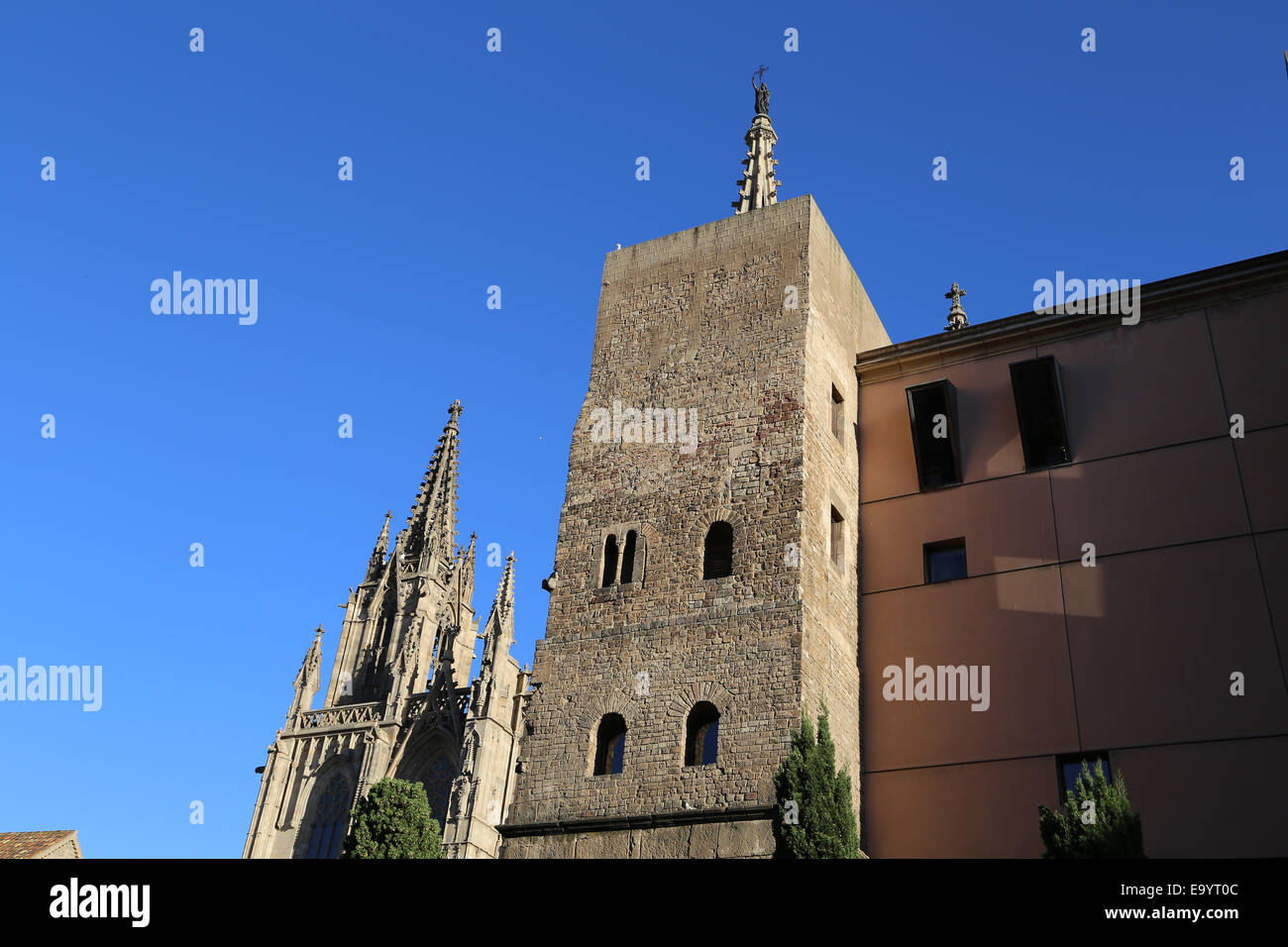 Spain. Catalonia. Barcelona. Tower from the second roman city wall (3rd-4th century) and facade neo-Gothic of  Cathedral,19th c. Stock Photo