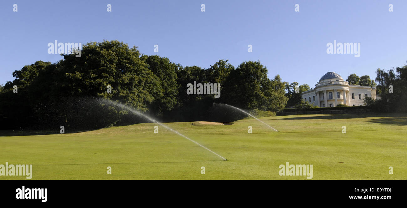 View over Fairway with Sprinklers on 14th Hole of  East Course Sundridge Park Golf Club to the Management Centre Bromley Kent En Stock Photo