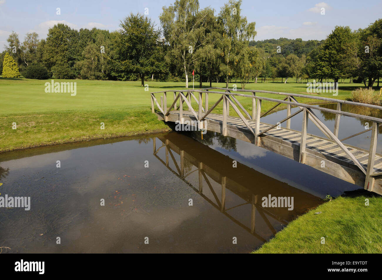 View over Pond with footbridge to 6th Green East Course Sundridge Park Golf Club Bromley Kent England Stock Photo