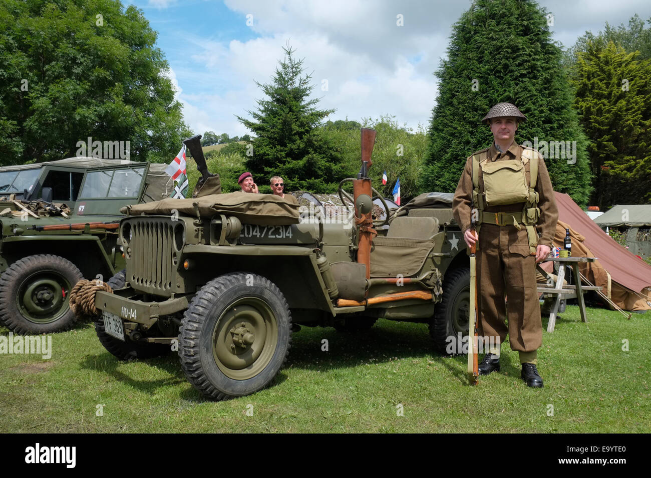 A sentry standing guard by a 1943 Willys jeep at a South Devon Railway 1940s weekend. Buckfastleigh, Devon England. Stock Photo