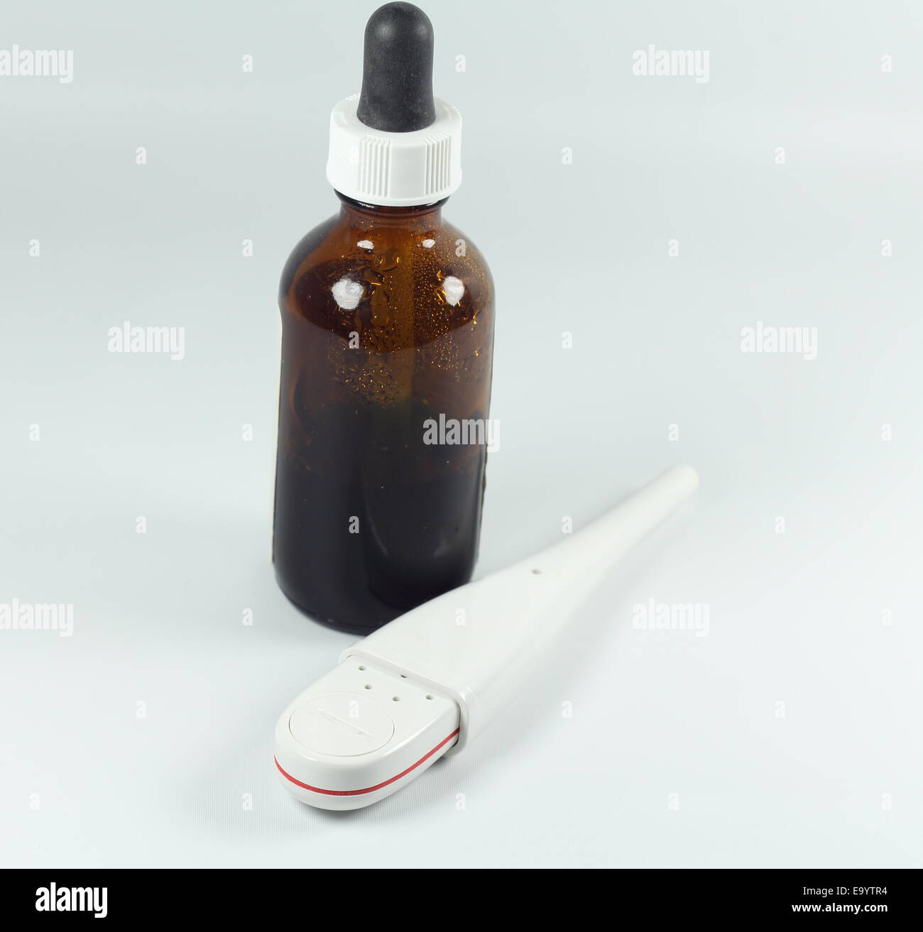 Medicine bottle /dispenser and a thermometer Stock Photo