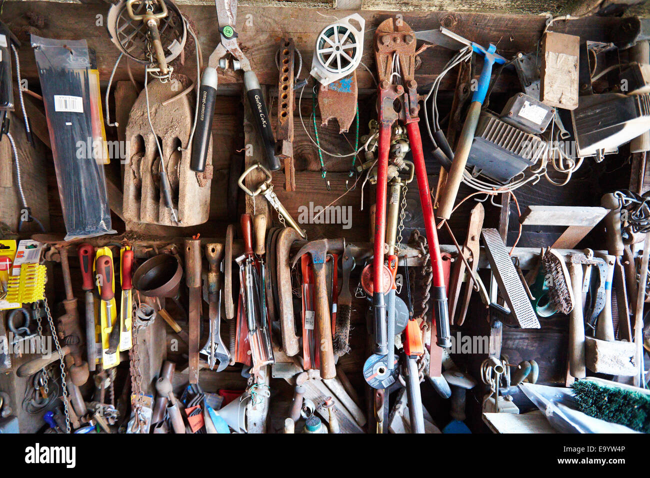 Old tools hanging on a wall in a farm Stock Photo Alamy