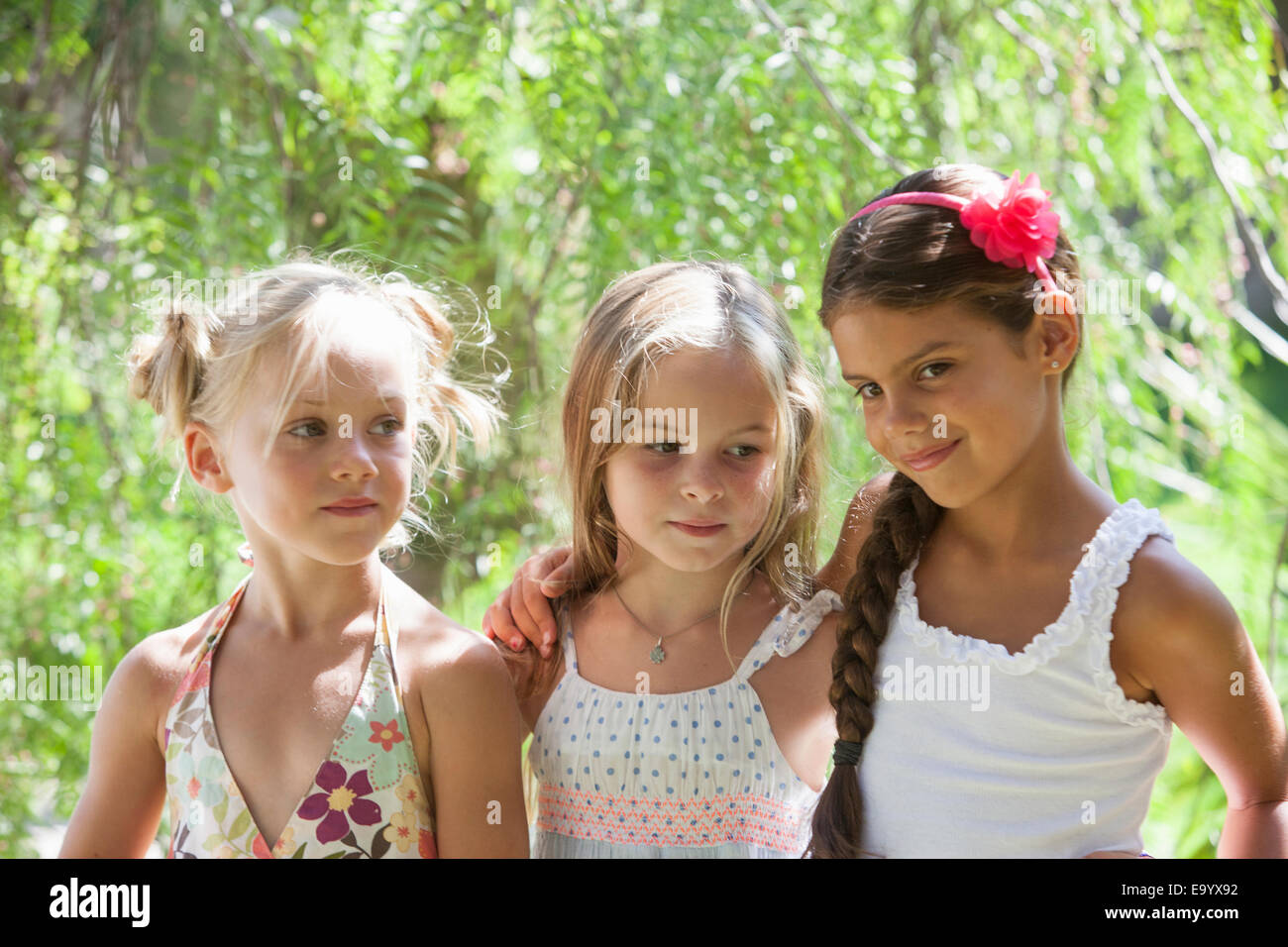 Candid portrait of three girls in garden Stock Photo