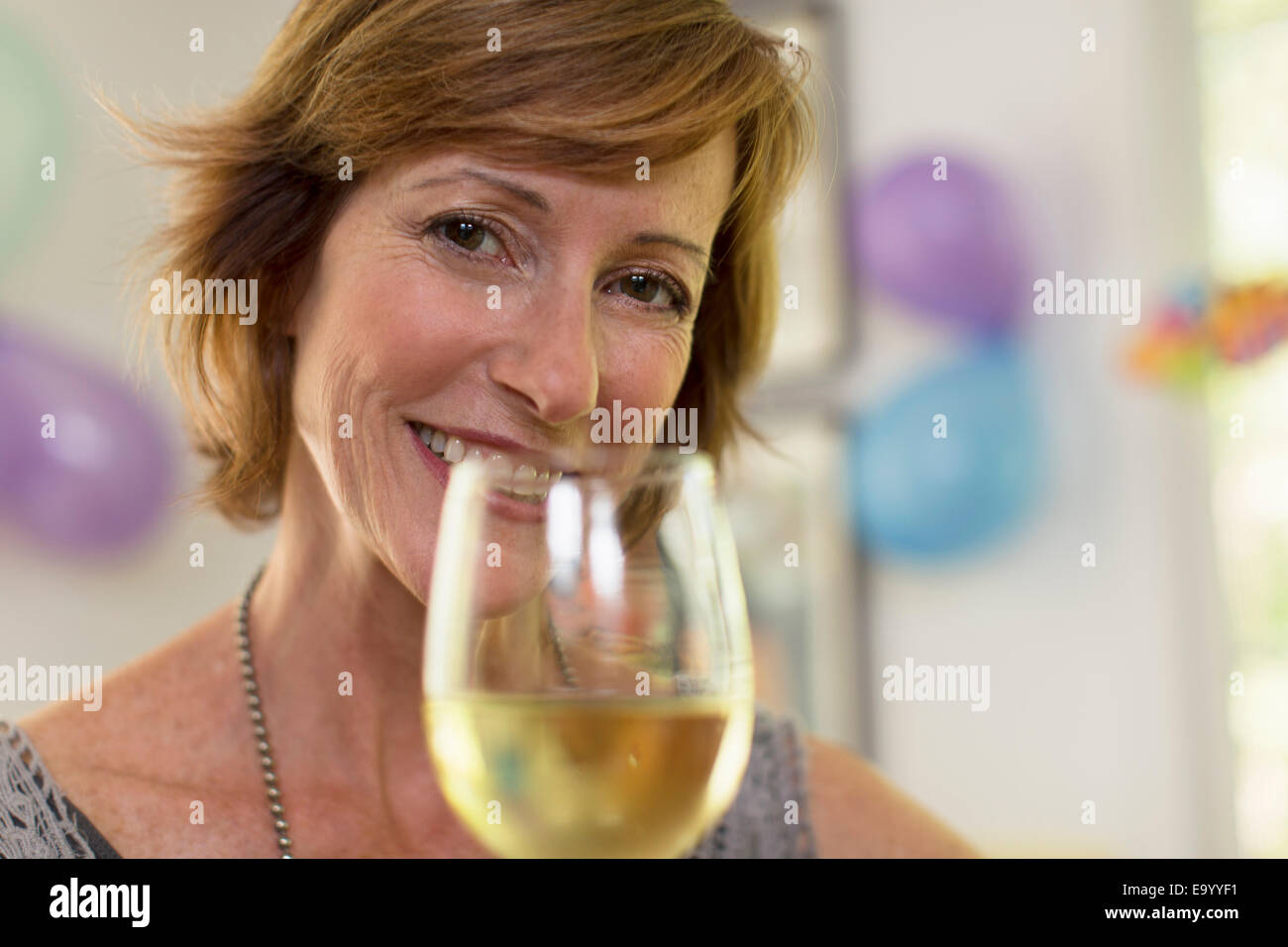 Portrait of mature woman holding glass of wine Stock Photo - Alamy