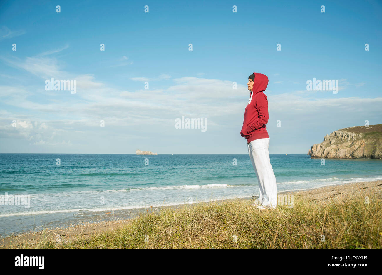Mature woman gazing at sea view, Camaret-sur-mer, Brittany, France Stock Photo