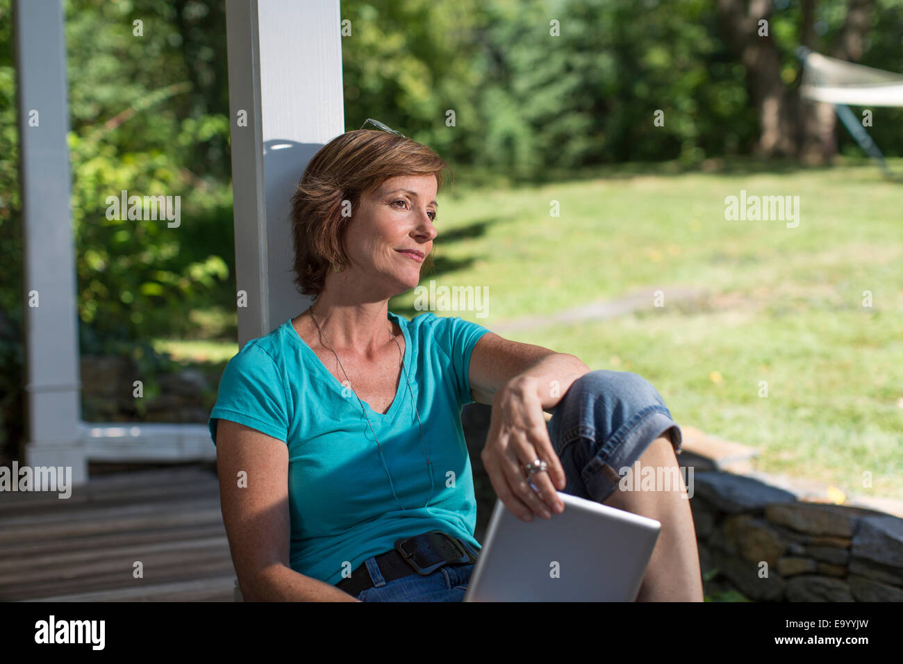 Mature woman sitting on veranda hi-res stock photography and images - Alamy
