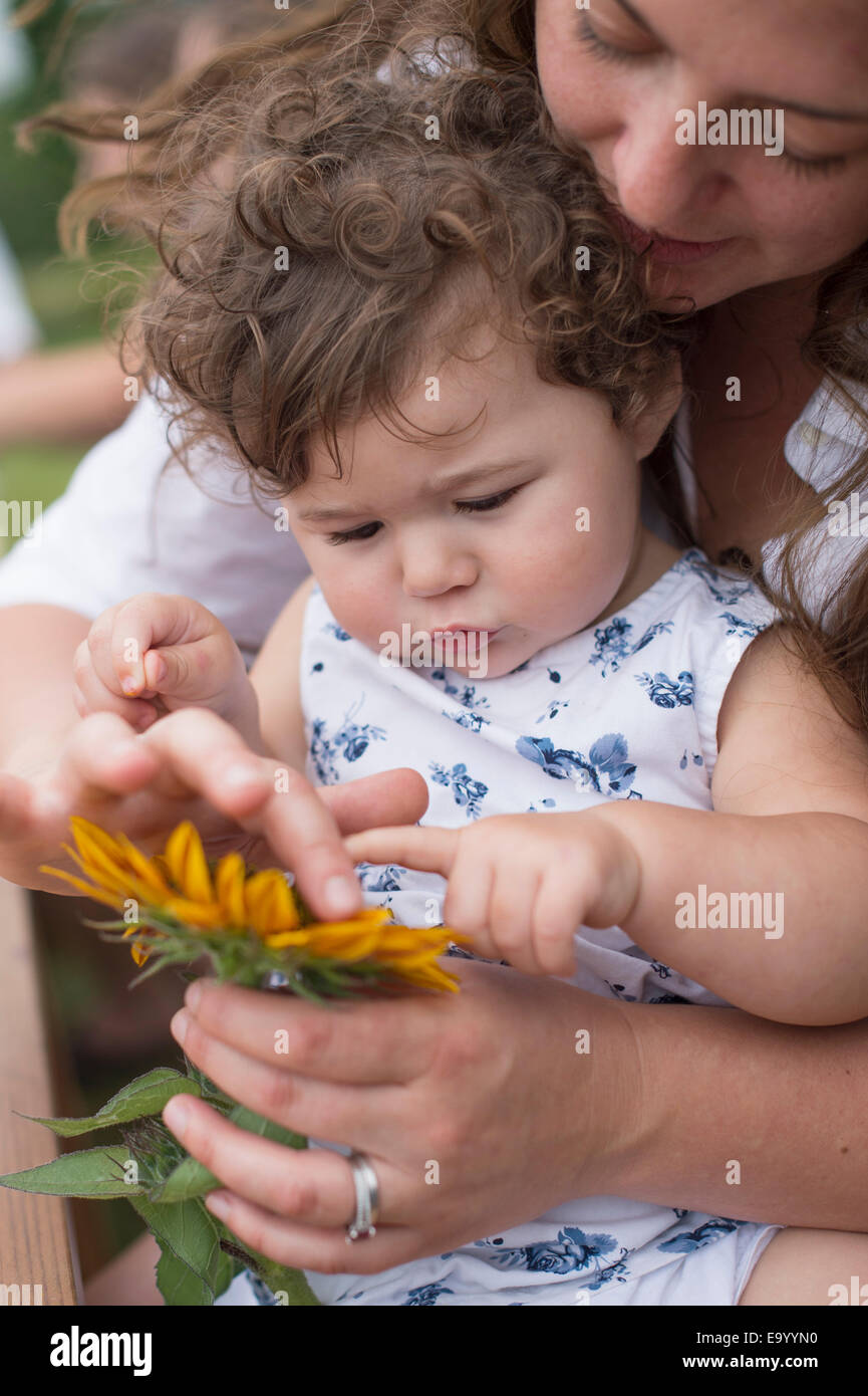 Mother and daughter looking at flower together Stock Photo Alamy