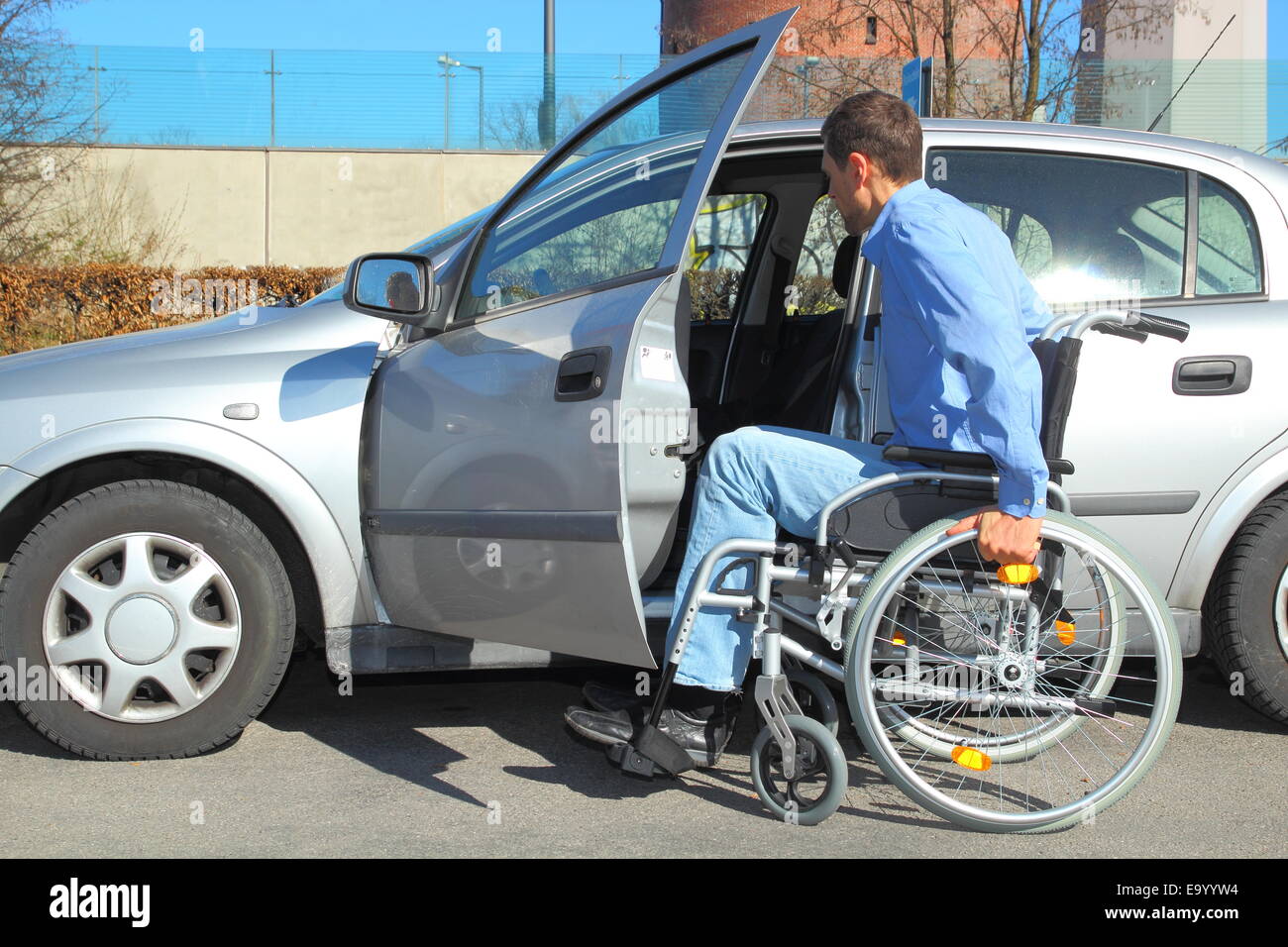 Wheelchair user getting into a car Stock Photo Alamy