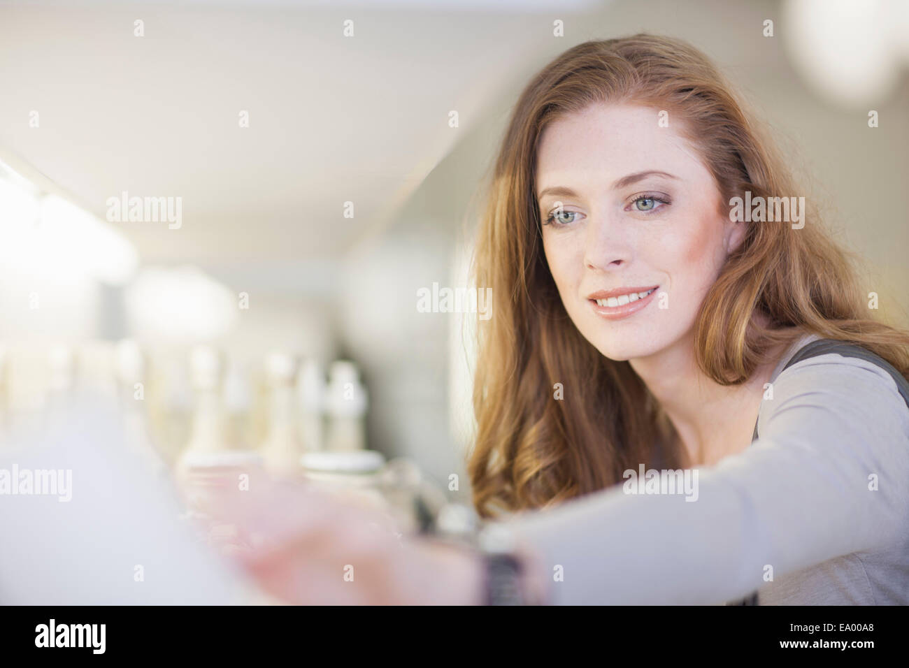 Woman browsing products on display shelf Stock Photo