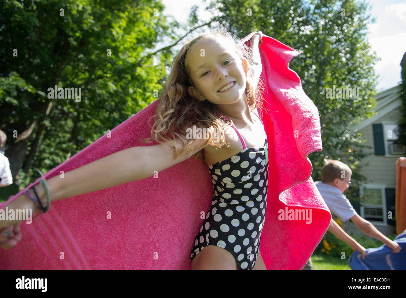 Girl in swimming costume holding towel Stock Photo Alamy