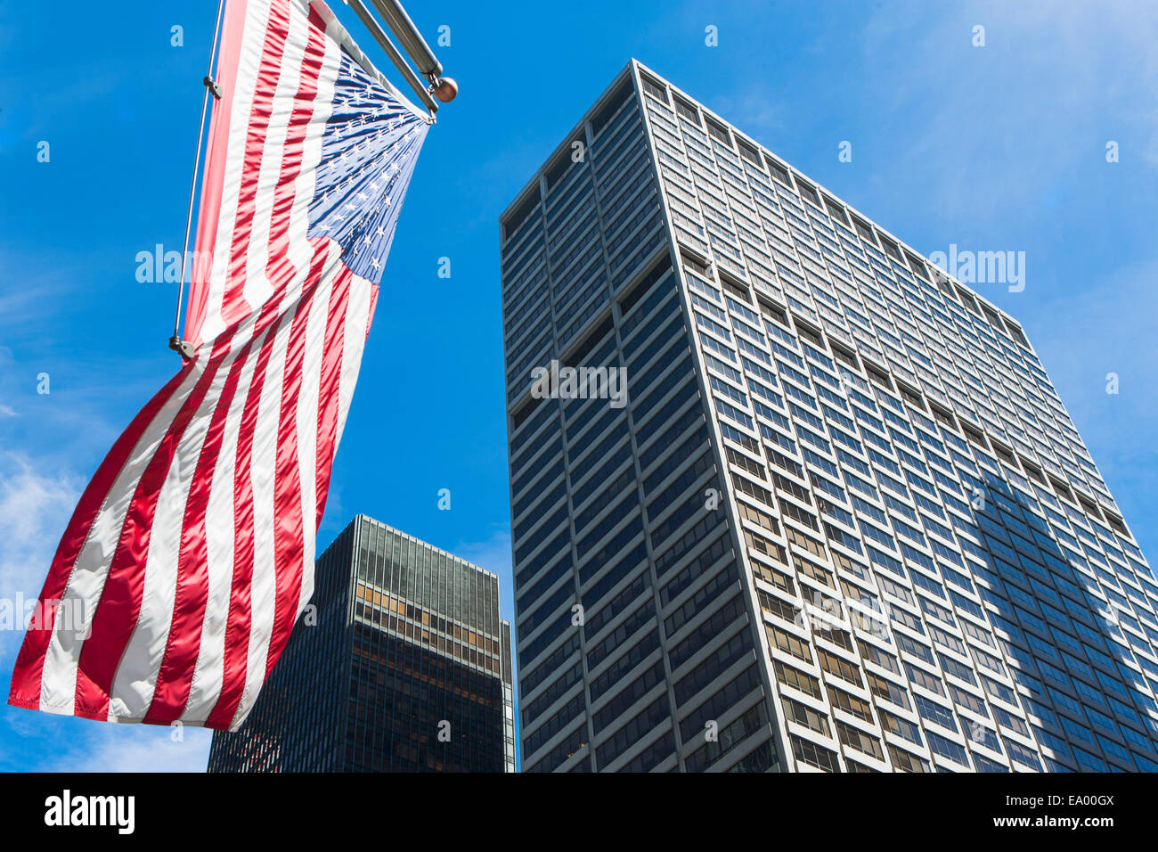 Low angled view of skyscrapers and American flag in financial district, Manhattan, New York, USA Stock Photo