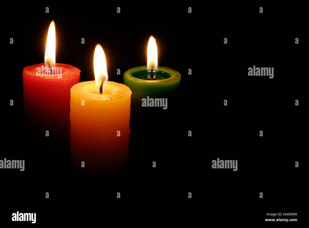 3 colored candles in the dark Stock Photo Alamy