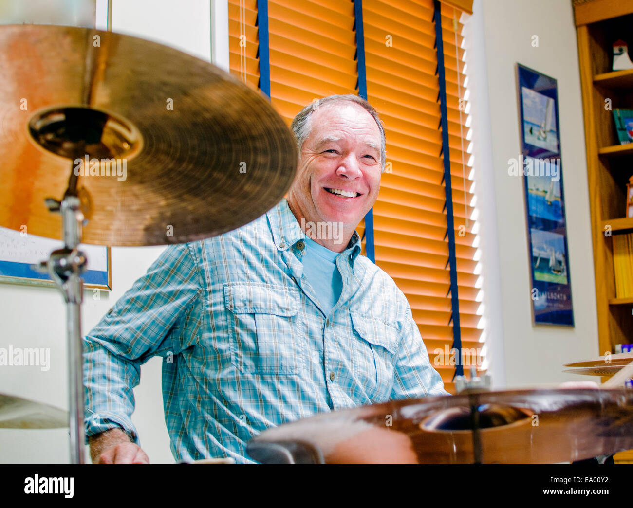 Mature man playing drums at home Stock Photo