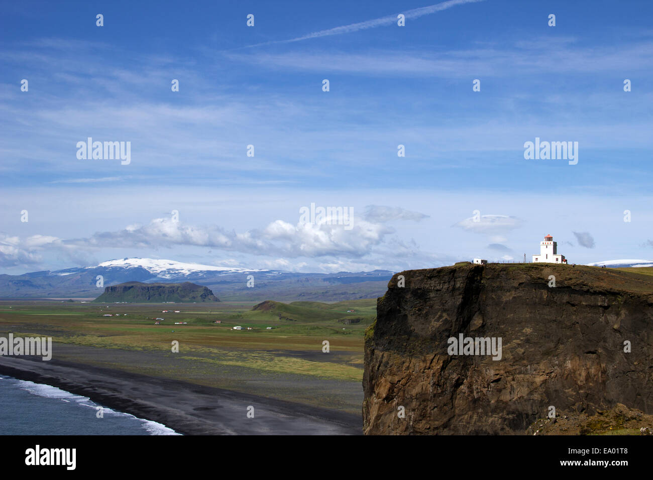 View from Dyrholaey Lighthouse towards the volcanic sand beach and mountain in the background Stock Photo