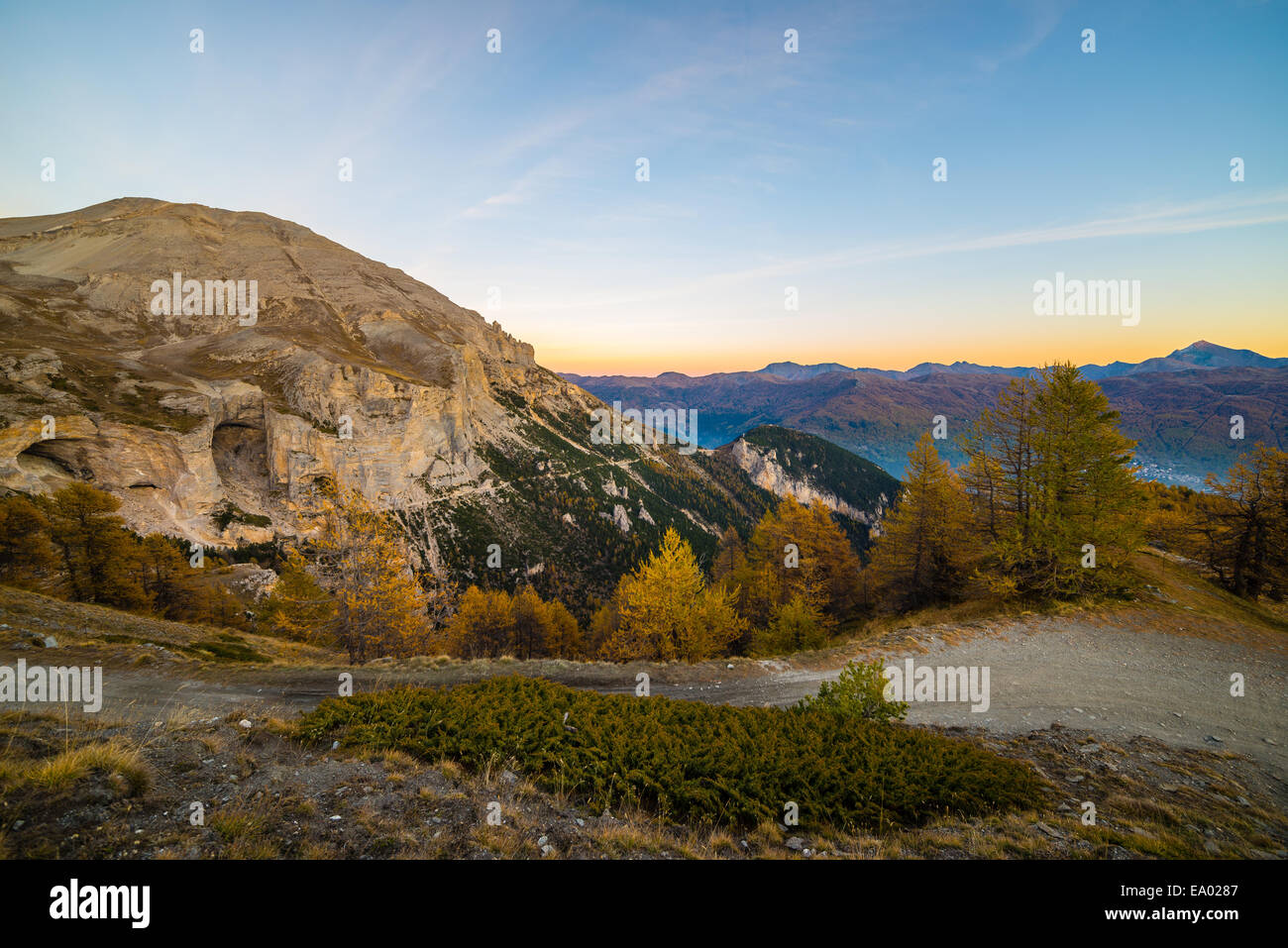 High altitude alpine landscape at dusk with panoramic view of misty ...