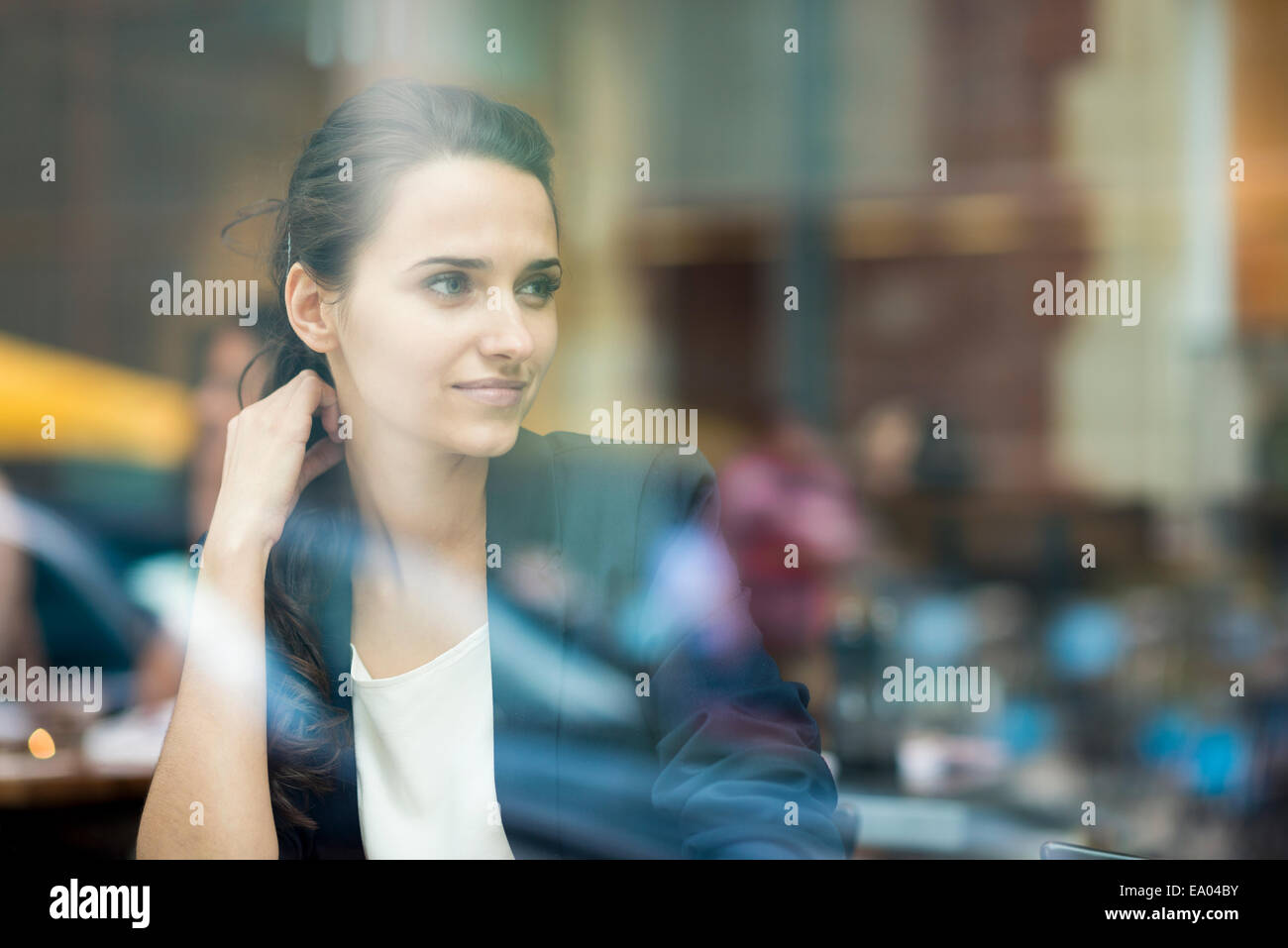 businesswoman looking out of cafe window, London, UK Stock Photo