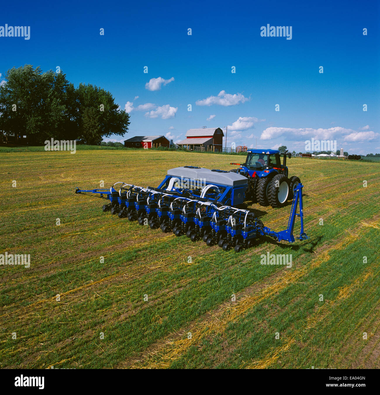 Agriculture New Holland tractor with air seeder drilling (planting