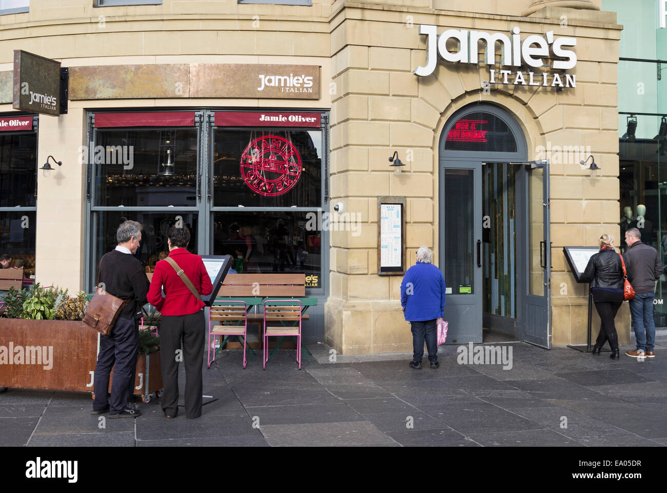 Potential customers browse the menu at Jamie's Italian restaurant, part owned by Jamie Oliver, in Newcastle upon Tyne. Stock Photo