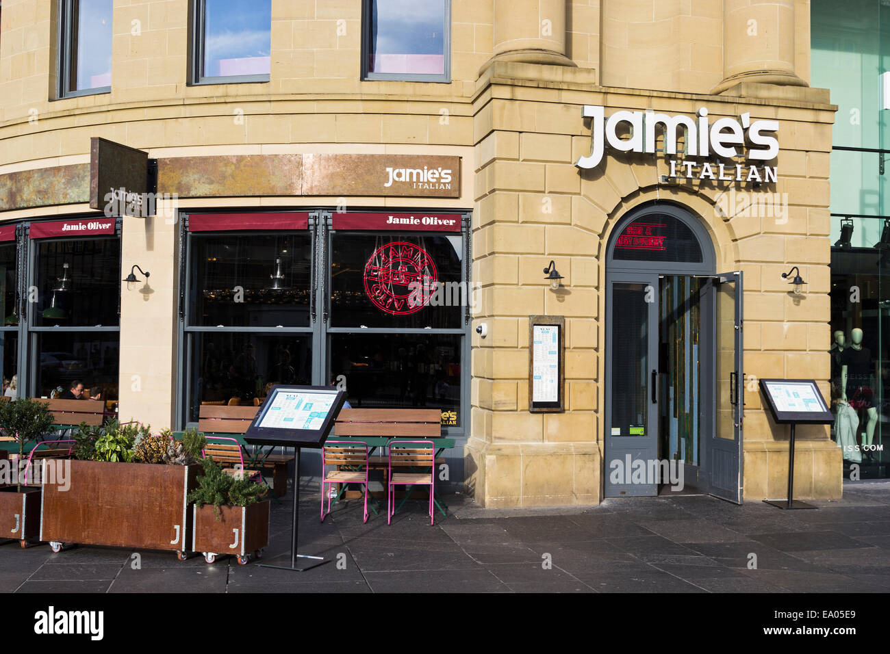 Jamie Oliver Italian restaurant at Newcastle upon Tyne showing exterior with diners inside and menu boards outside. Stock Photo