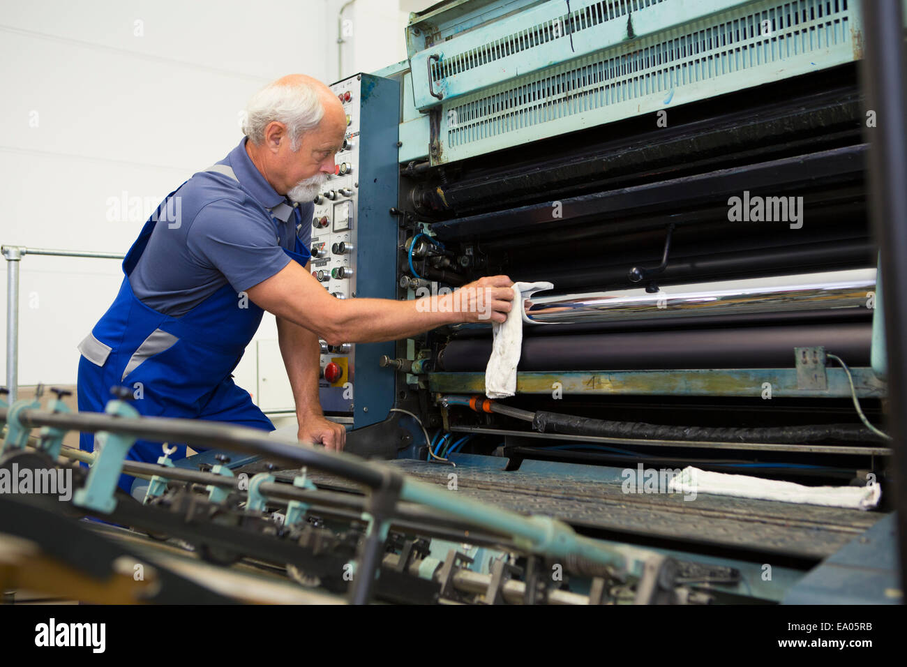 Factory worker cleaning machinery Stock Photo Alamy