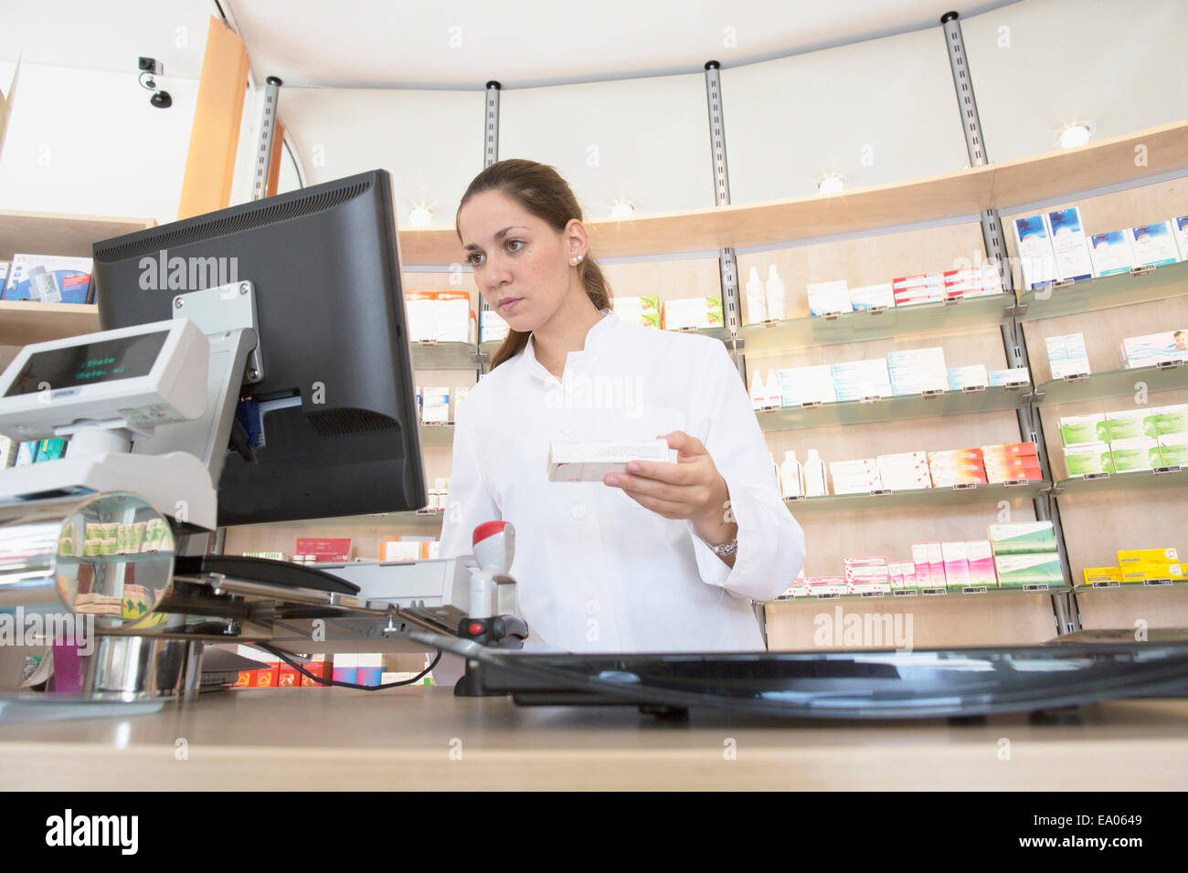 Pharmacist in pharmacy using computer Stock Photo