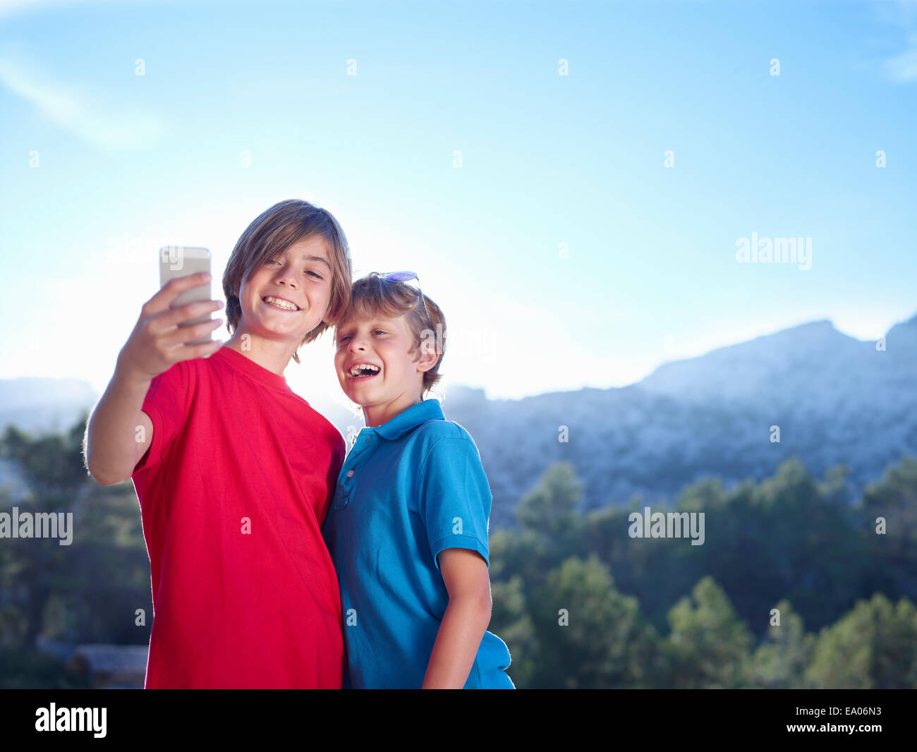 Two brothers taking selfie on smartphone, Majorca, Spain Stock Photo
