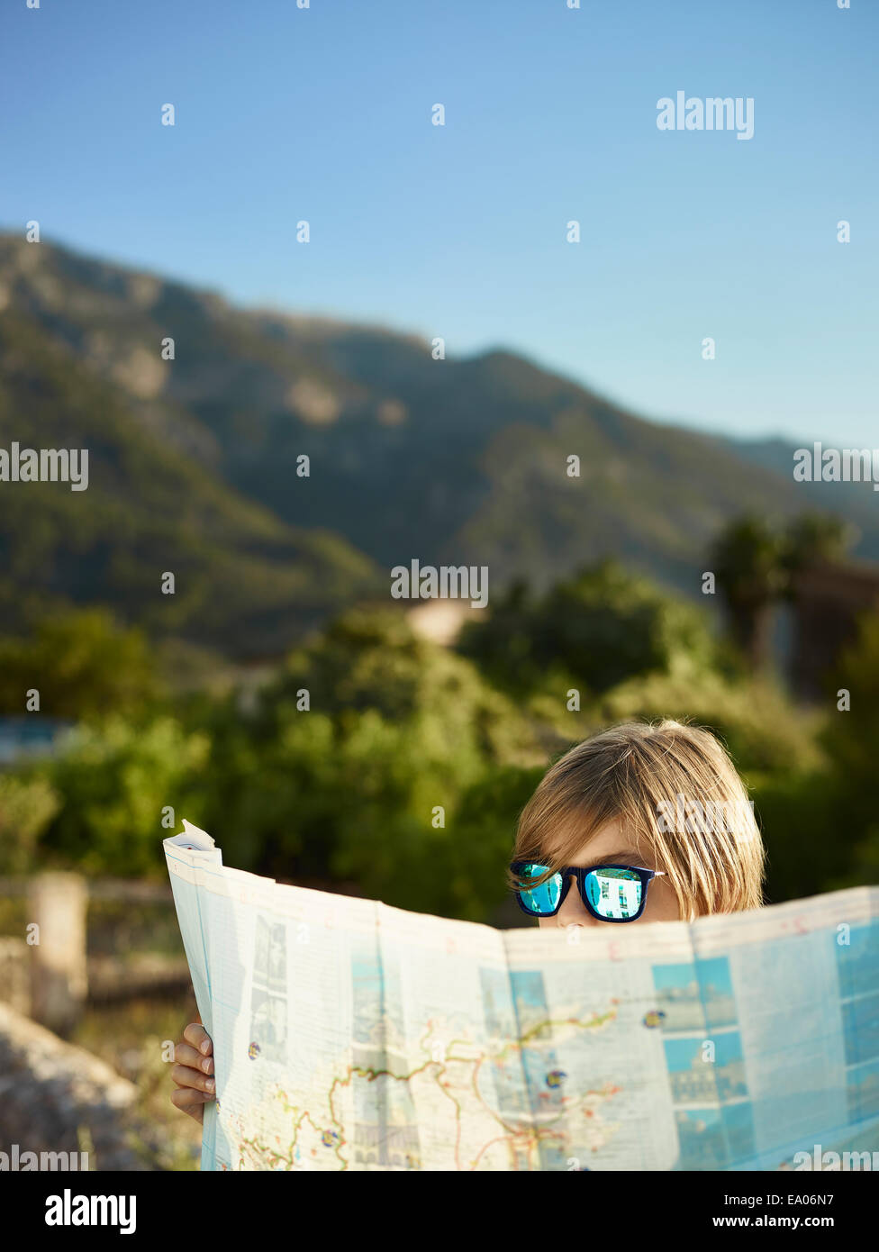 Boy in sunglasses looking at a map, Majorca, Spain Stock Photo