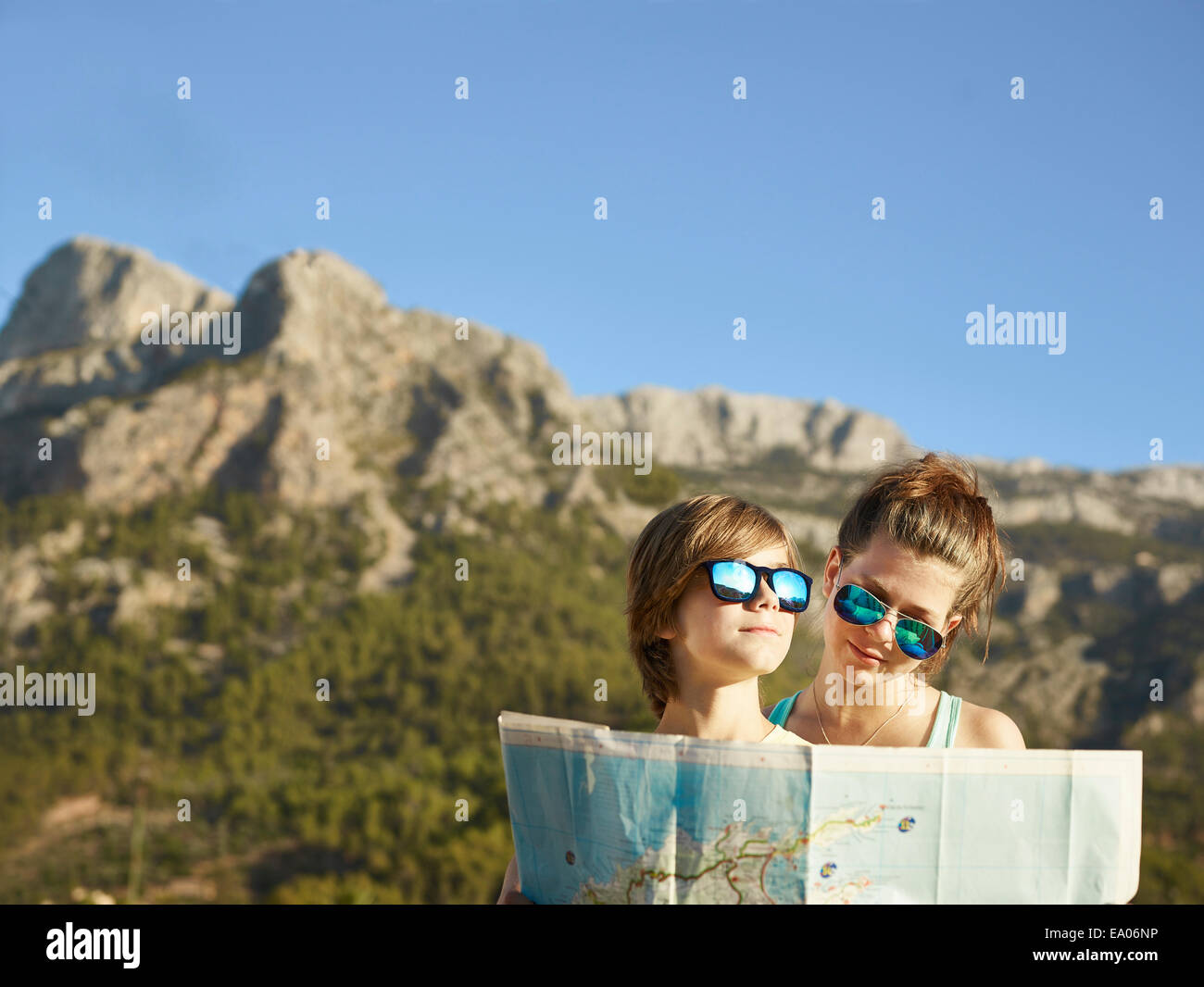 Teenage girl and brother looking at map, Majorca, Spain Stock Photo