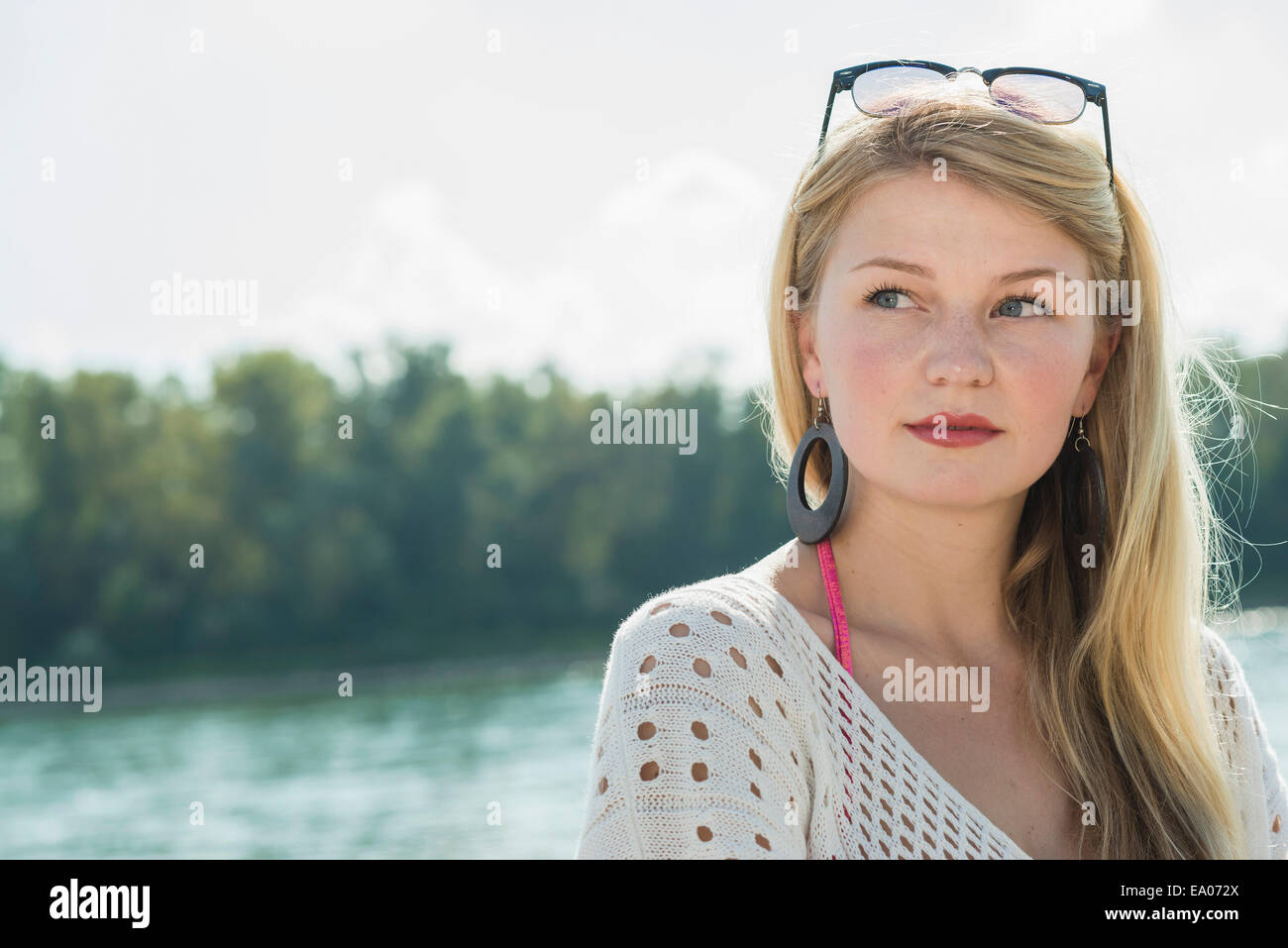 Young woman with long blonde hair looking away, portrait Stock Photo