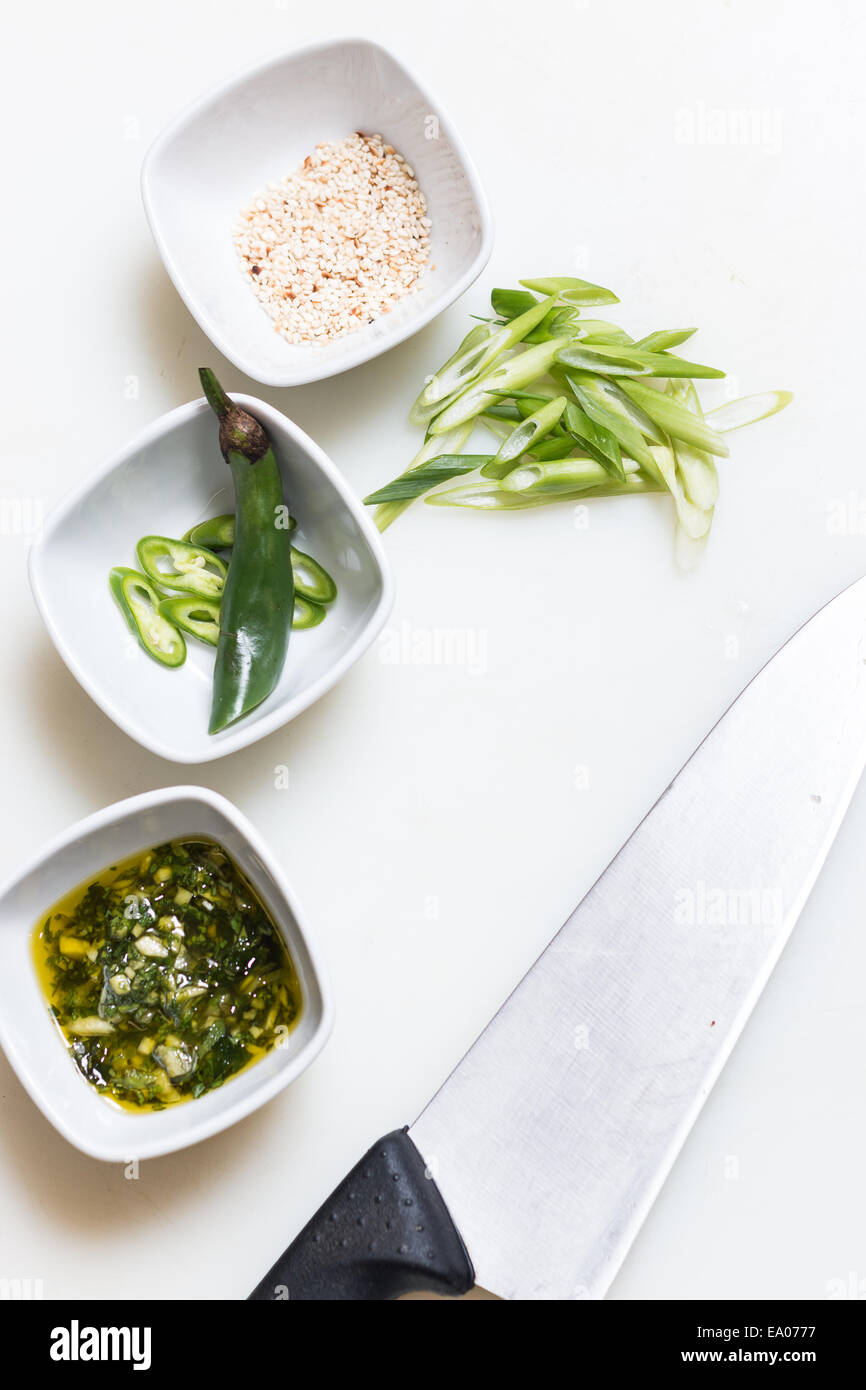 Sesame seeds, pesto sauce and freshly cut chillies on white sauce dippers Stock Photo