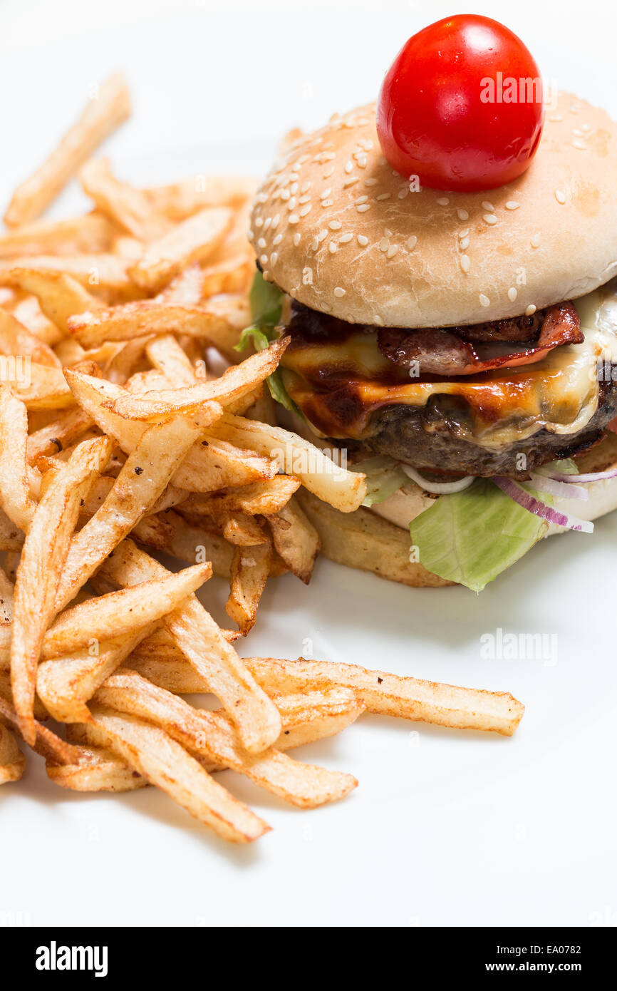Burger and french fries on a white plate Stock Photo