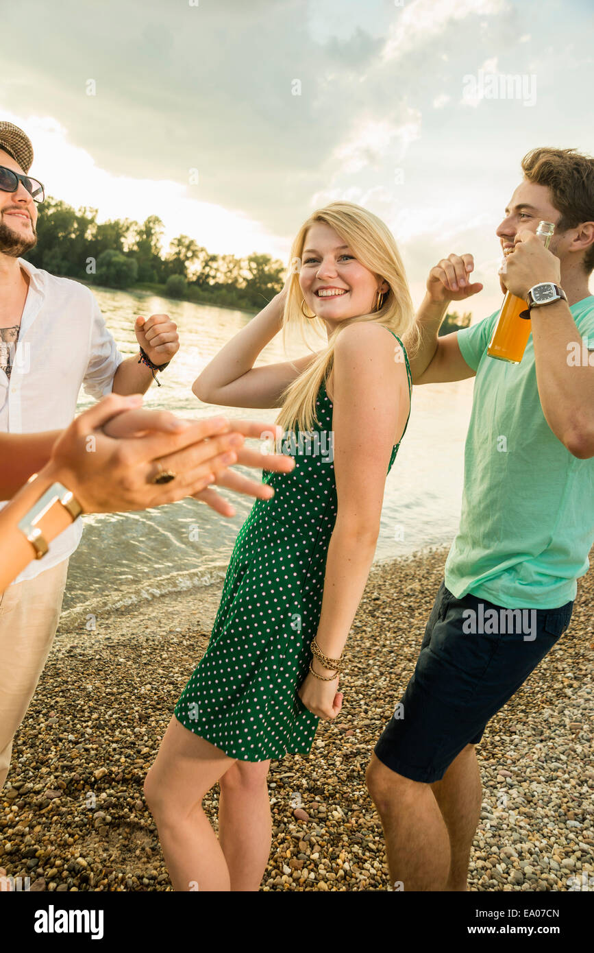 Group of friends dancing on beach Stock Photo