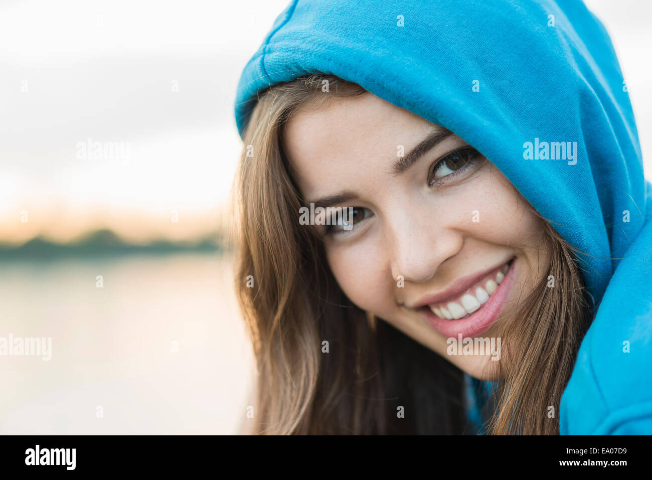 Young woman wearing blue hooded top Stock Photo
