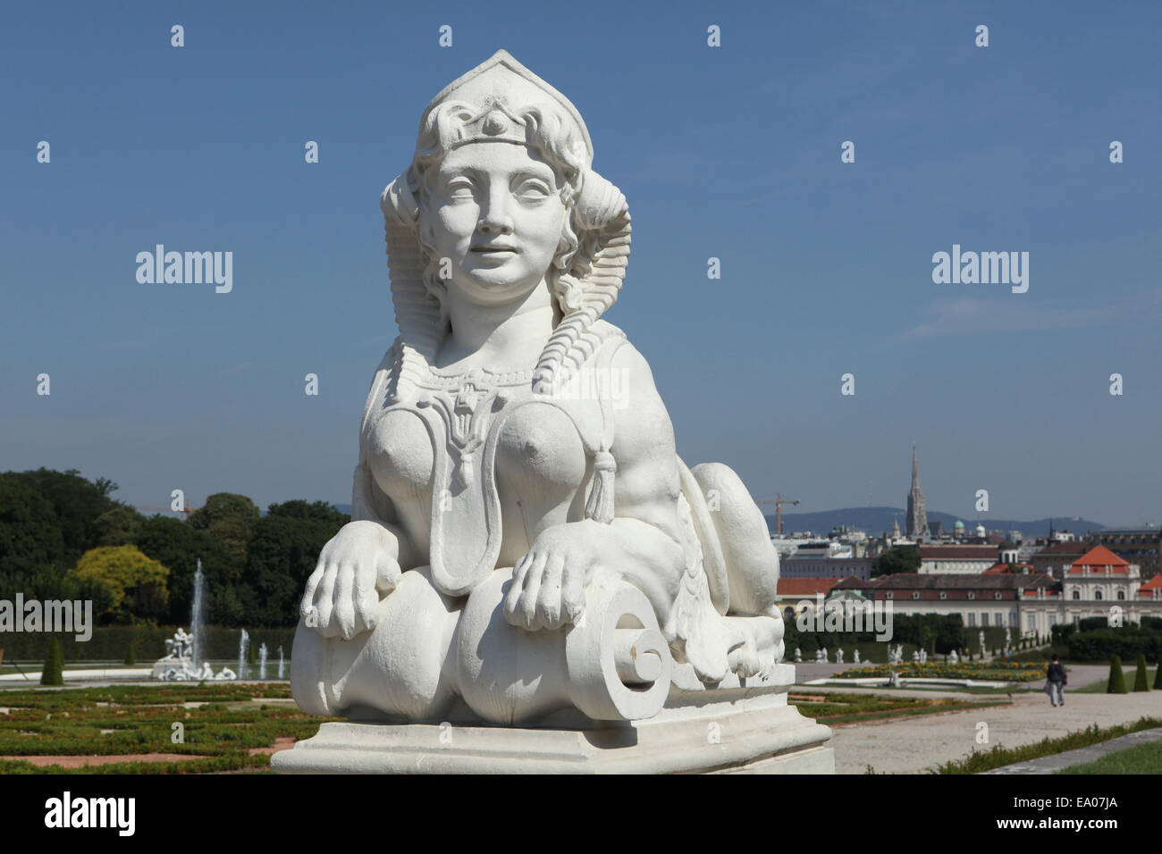 Rococo Sphinx in the Belvedere gardens in Vienna, Austria. St Stephen's Cathedral in seen in the background. Stock Photo