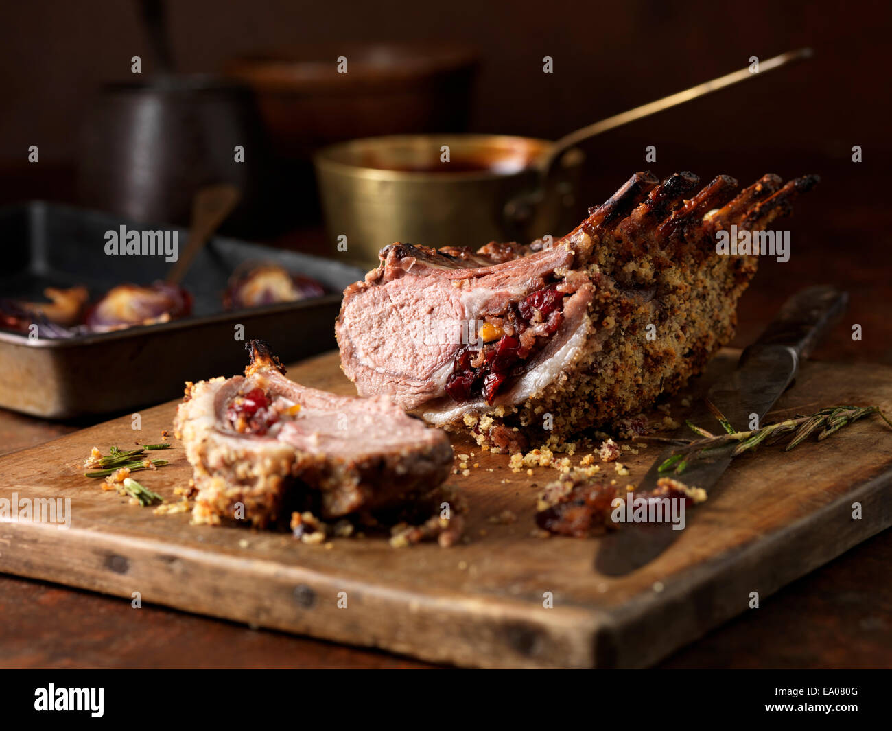 Christmas dinner. Lamb rack rare medium with cranberry and clementine stuffing and rosemary Stock Photo
