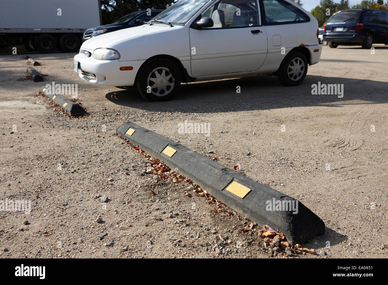 wheel stopper parking block in a rough car park Saskatchewan Canada Stock Photo