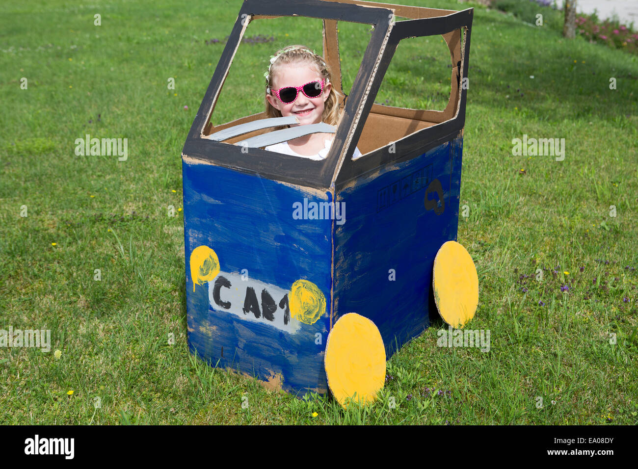 Girl playing in homemade toy car Stock Photo